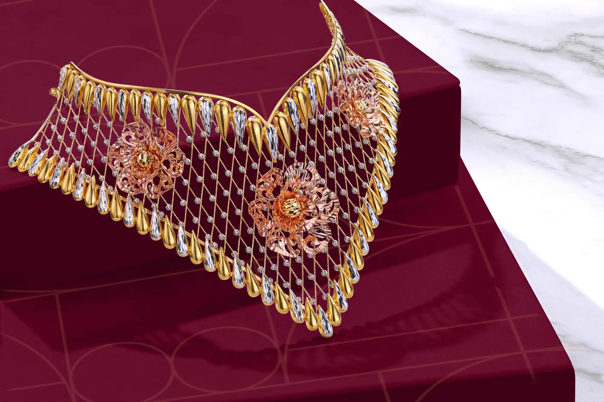 A multi-tone 22K gold floral choker by Dhakan Jewellers on deep maroon