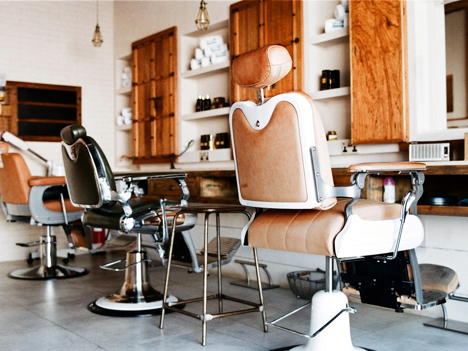 Wide view of the barber floor with chairs, mirrors and shelving
