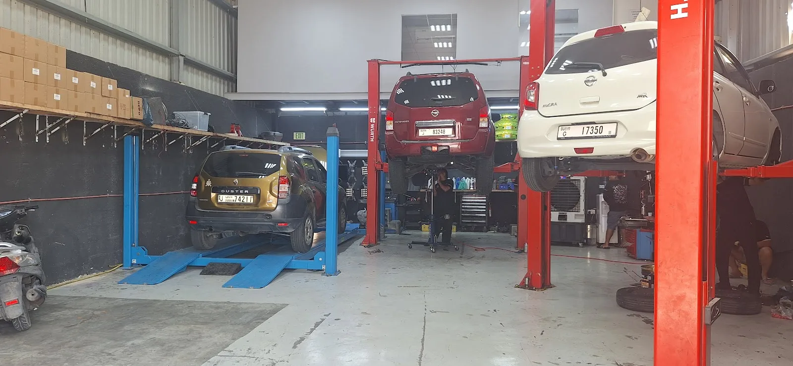 Several cars on lifts in the Pinoy Auto Garage workshop