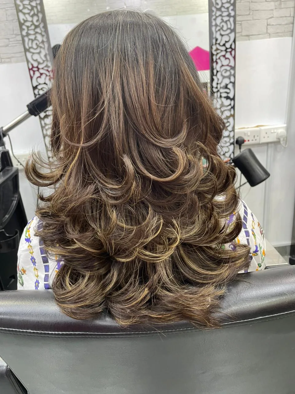 Bouncy layered blow-dry styled at the salon