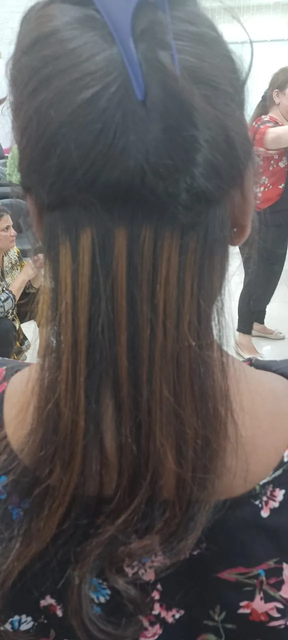 Long hair extensions blended into natural hair