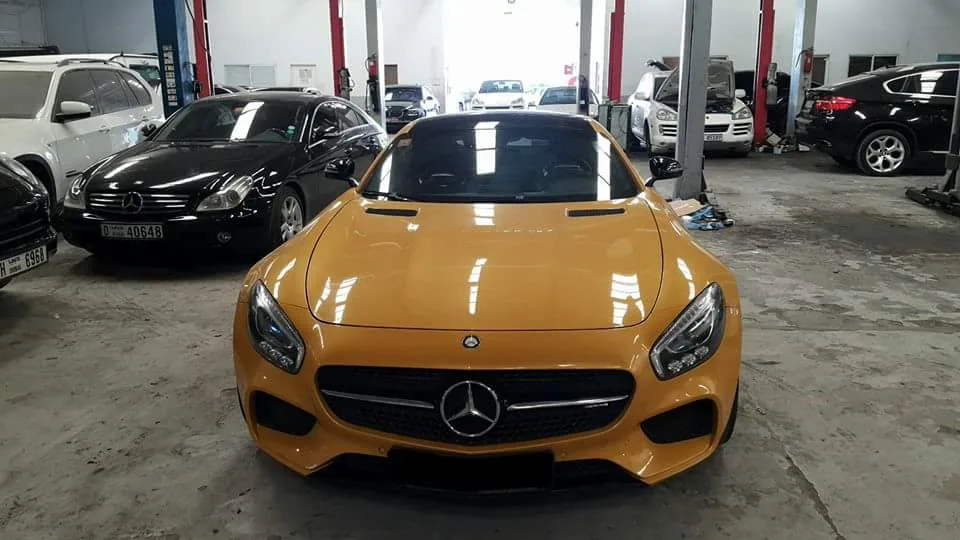 Yellow Mercedes-AMG GT in the workshop