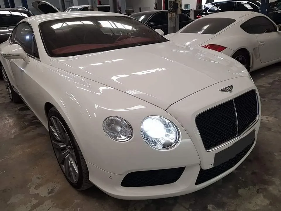 White Bentley Continental GT being serviced