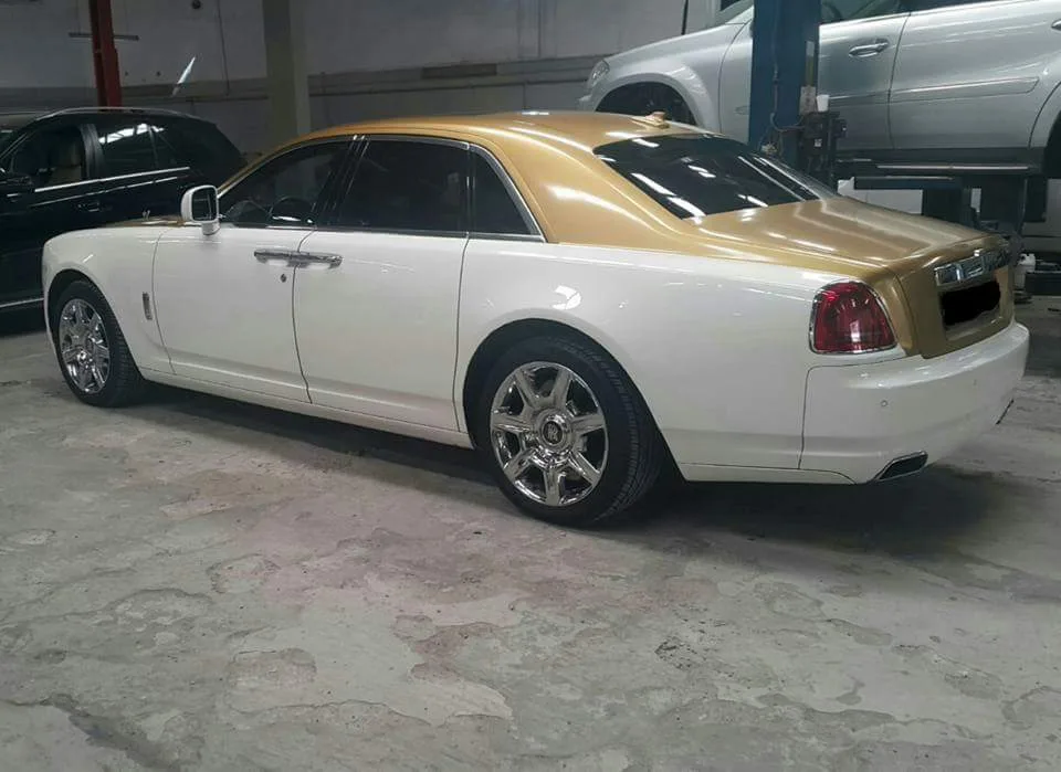 White and gold Rolls-Royce Ghost in for service