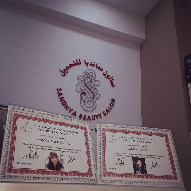Ten-year service appreciation certificates displayed at the salon