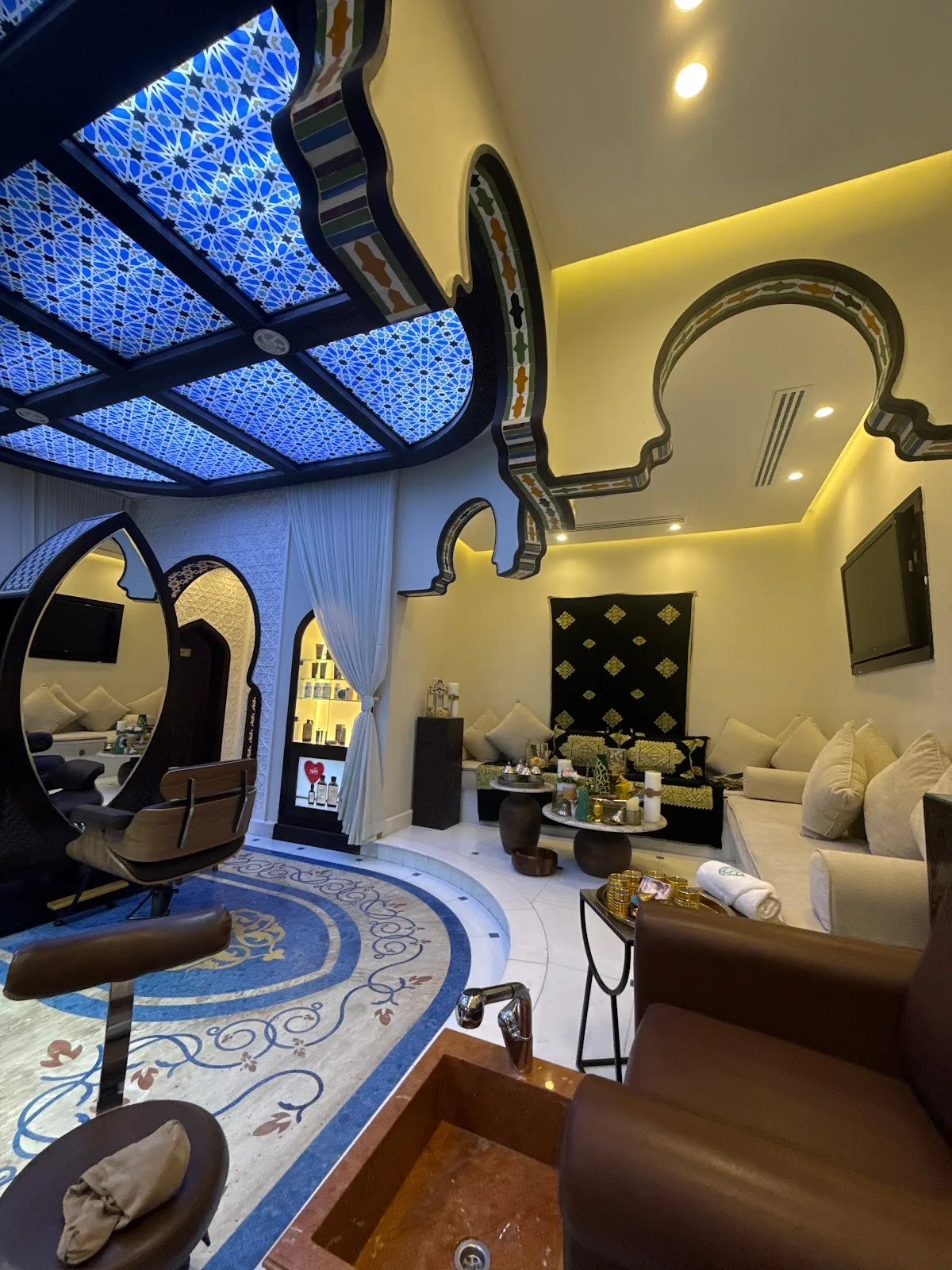 Lounge with blue zellige mosaic ceiling and Moroccan seating