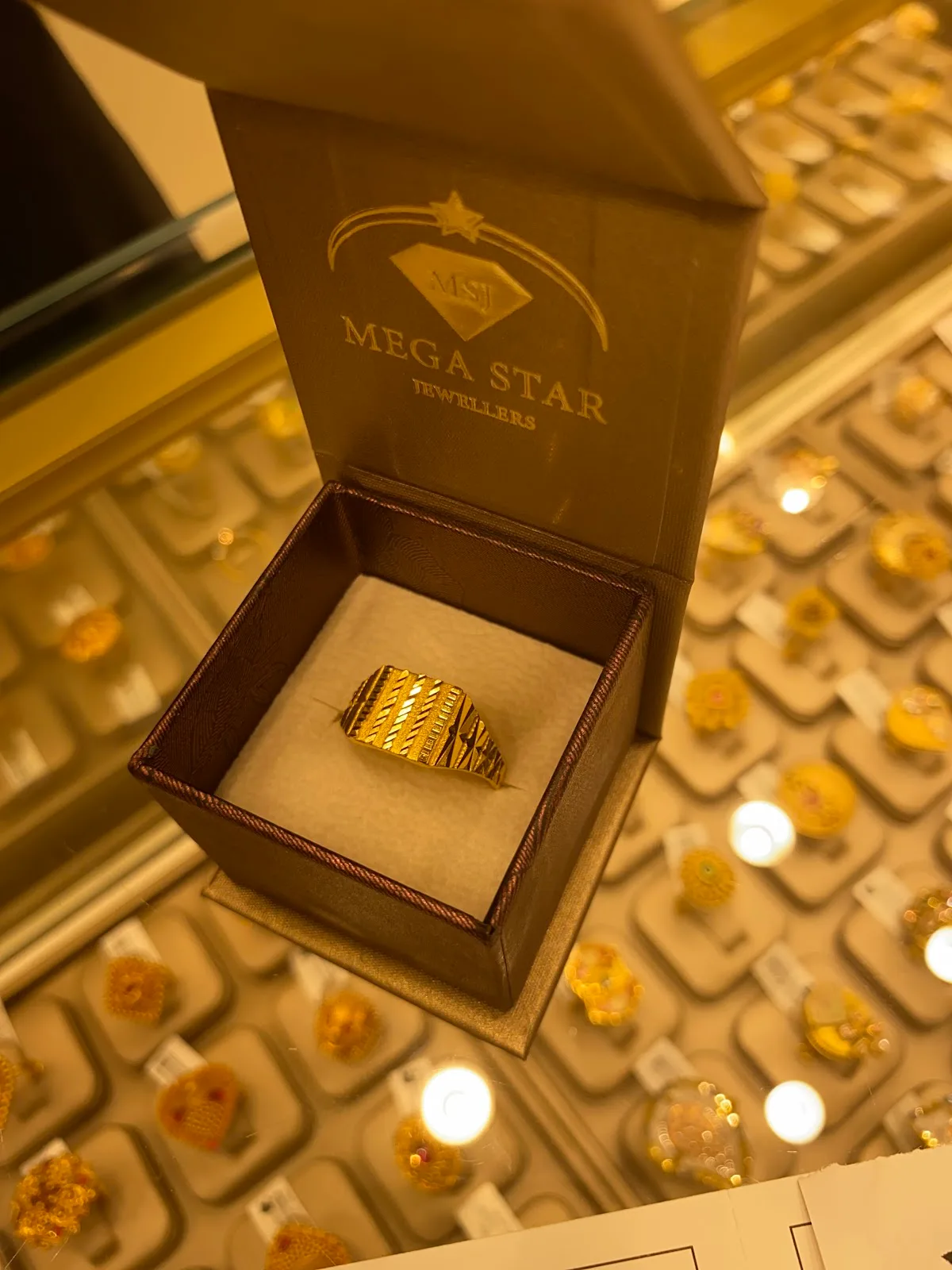 Gold ring presented in a Mega Star Jewellers gift box