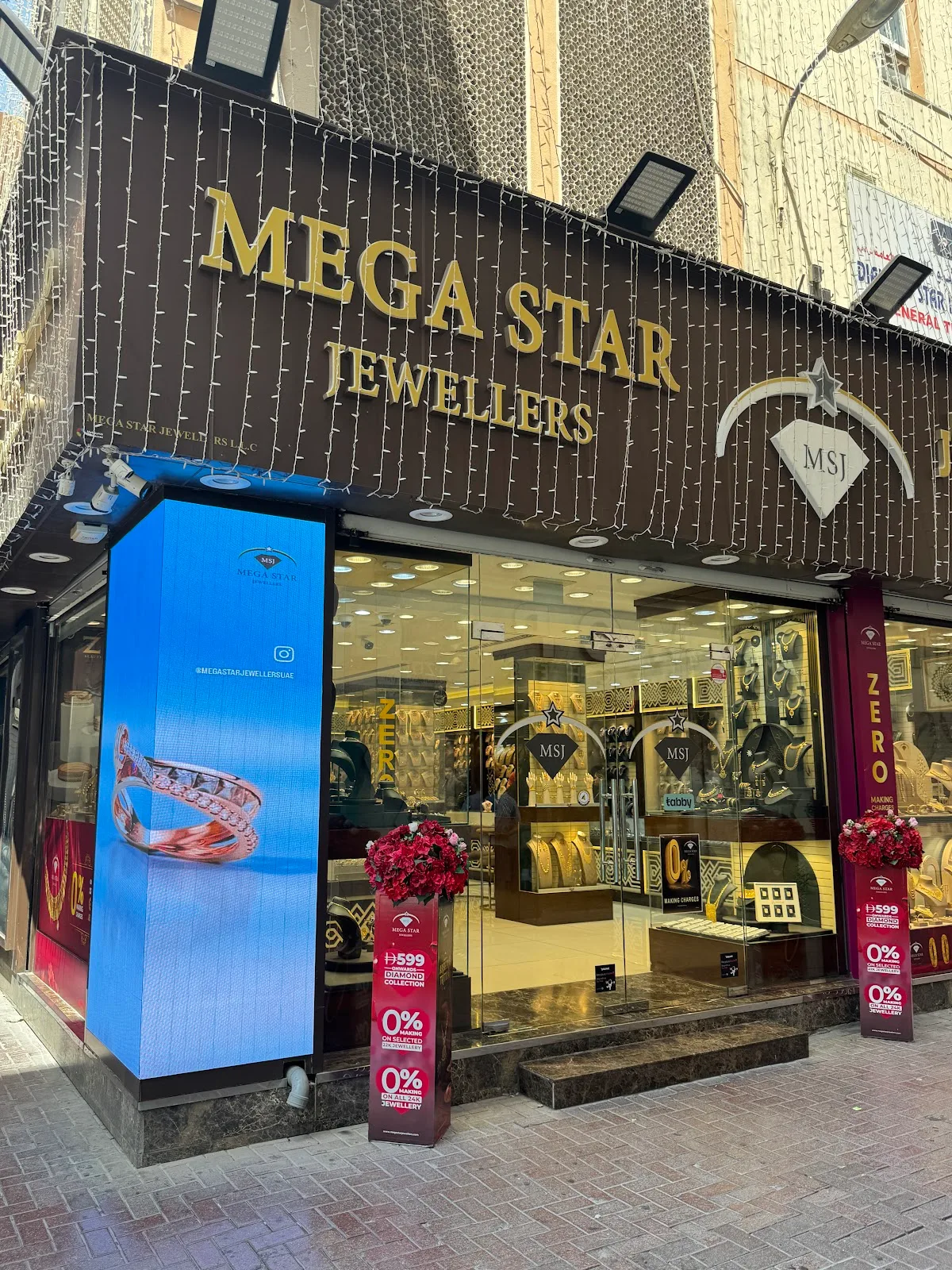 Mega Star Jewellers storefront at night with the gold sign lit