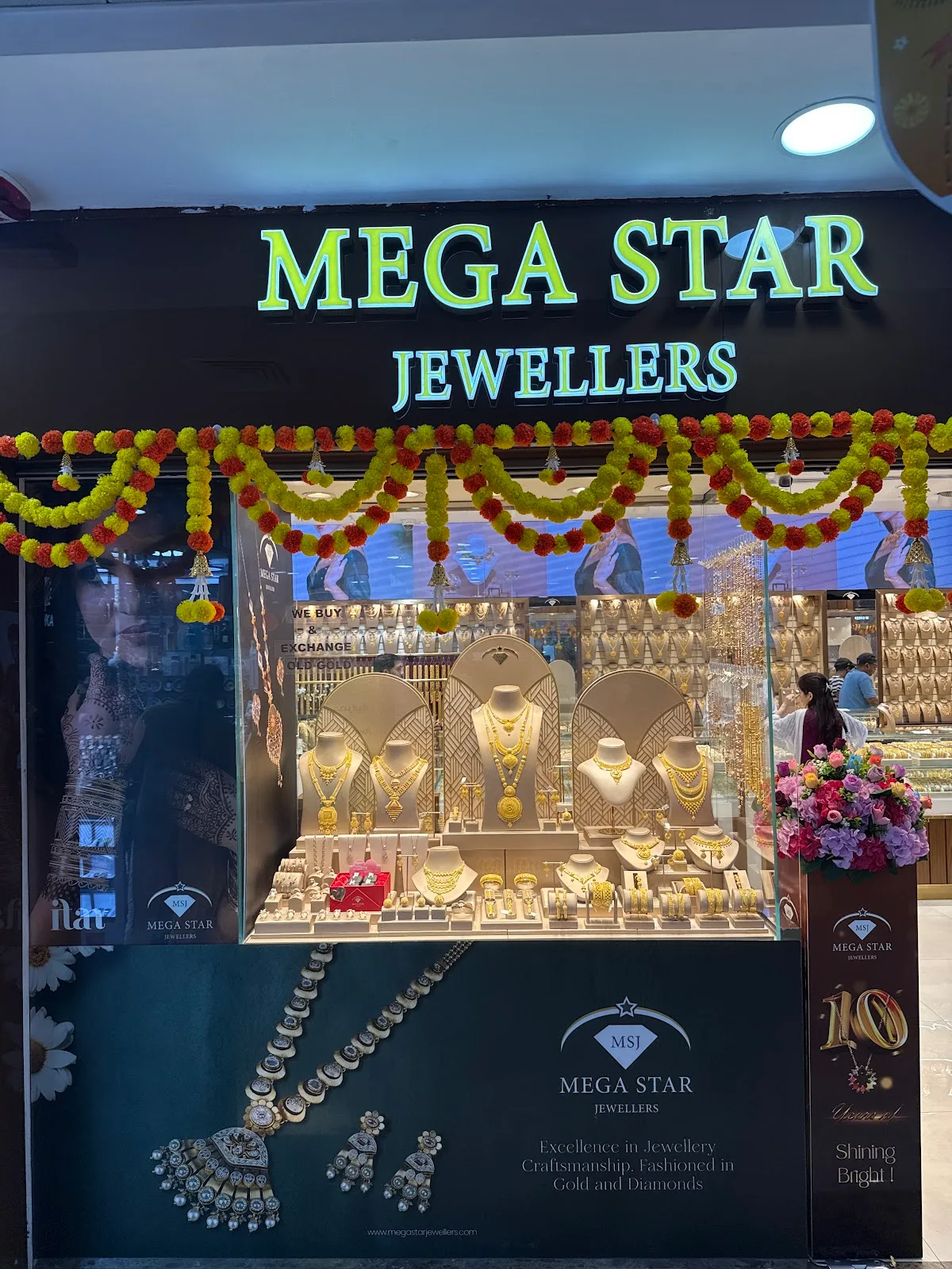Mega Star Jewellers window display with gold sets and the brand tagline