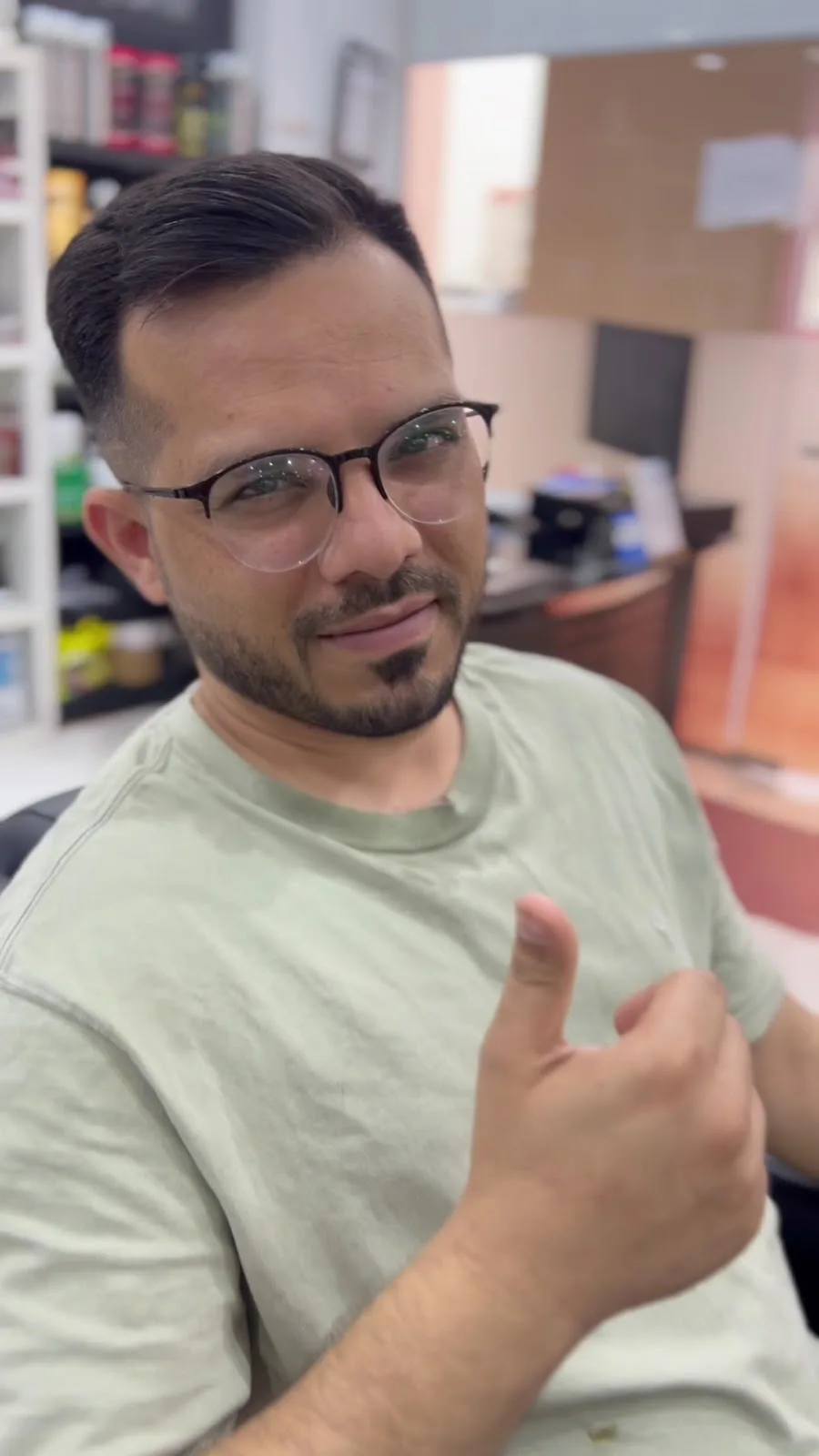 Smiling client giving a thumbs up after a fresh haircut at VOOM Gents Salon