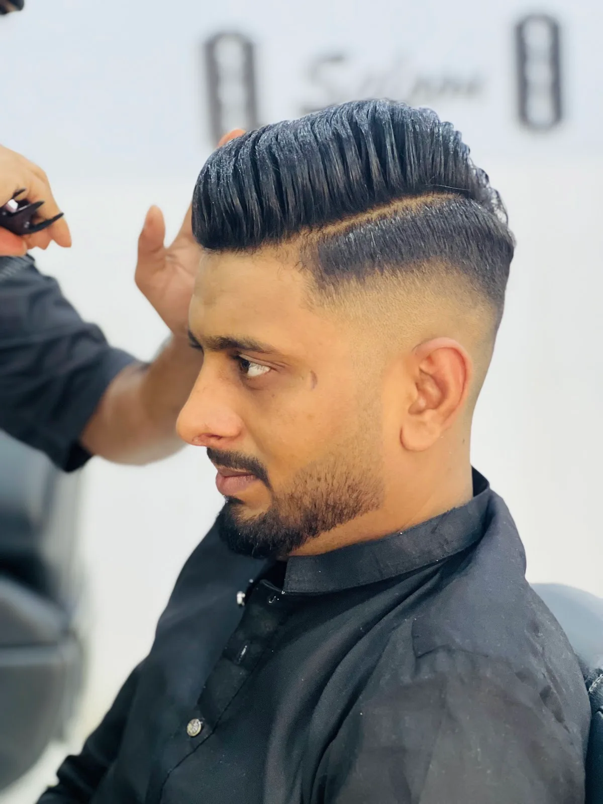 Men's pompadour with a high skin fade styled at VOOM Gents Salon