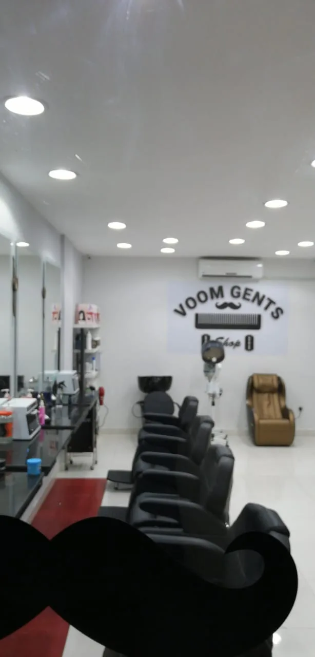 Wide view of the VOOM Gents Salon interior with the comb, razor and moustache wall logo