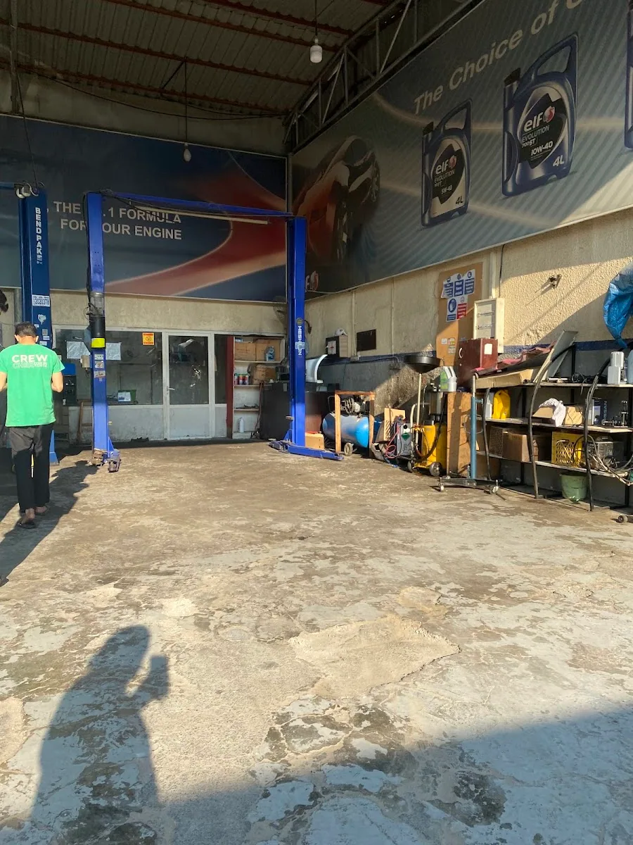 Inside Man City Garage showing the service bays and elf branded workshop wall