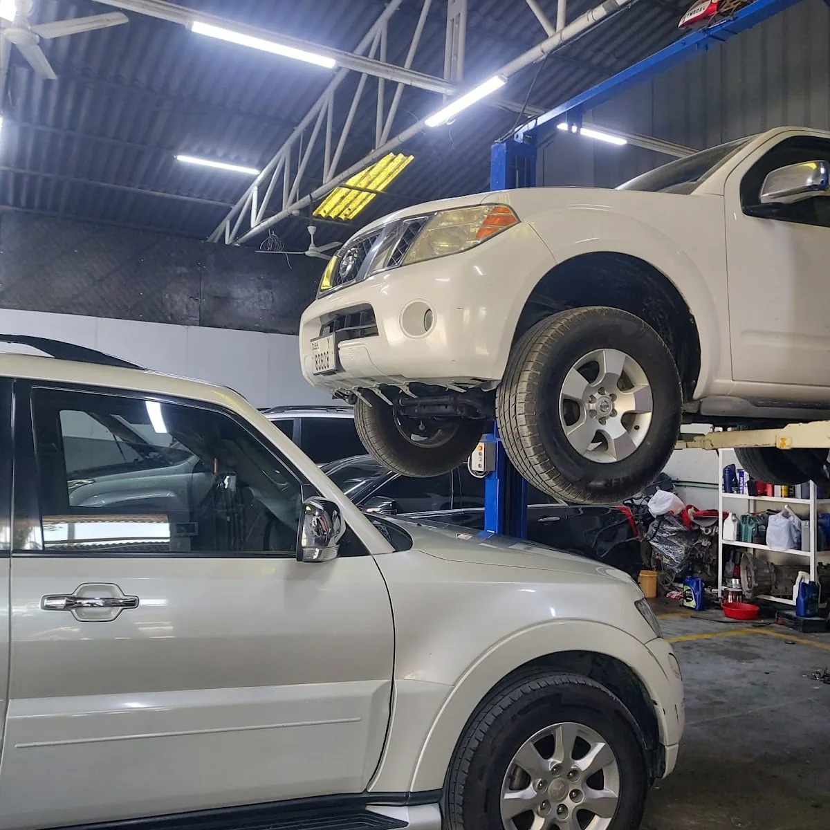 A vehicle on the lift with its engine removed during a major repair