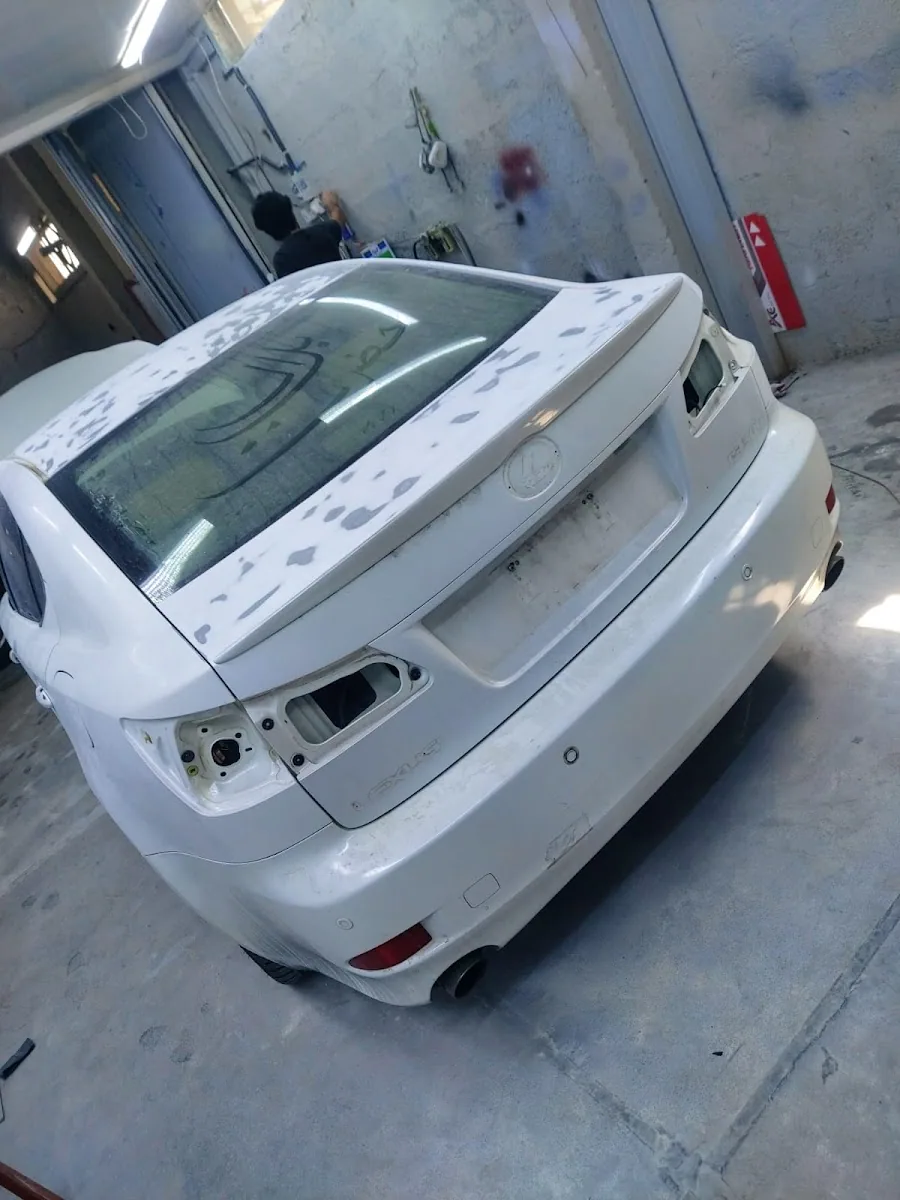 A white Lexus prepped and sanded before respray at Man City Garage