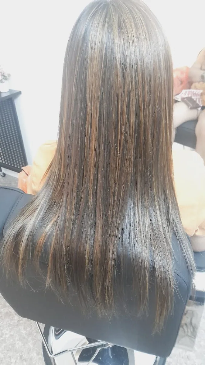 Glossy, smooth straightened hair after a keratin treatment