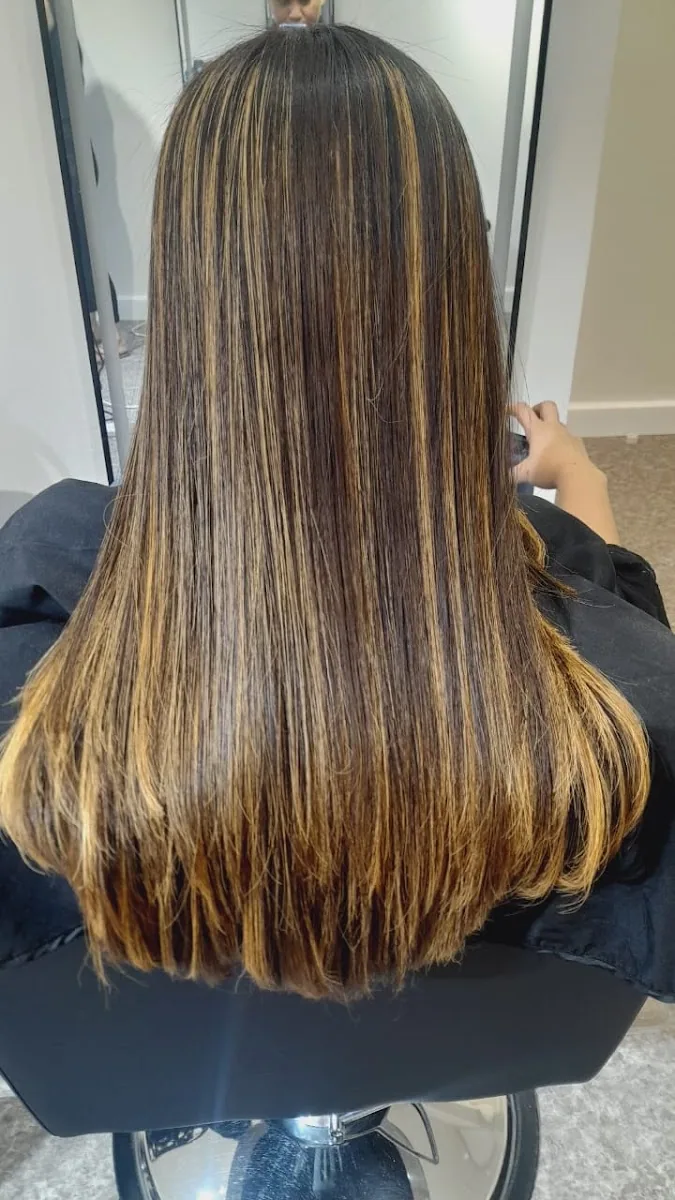 Long straightened hair with warm caramel highlights