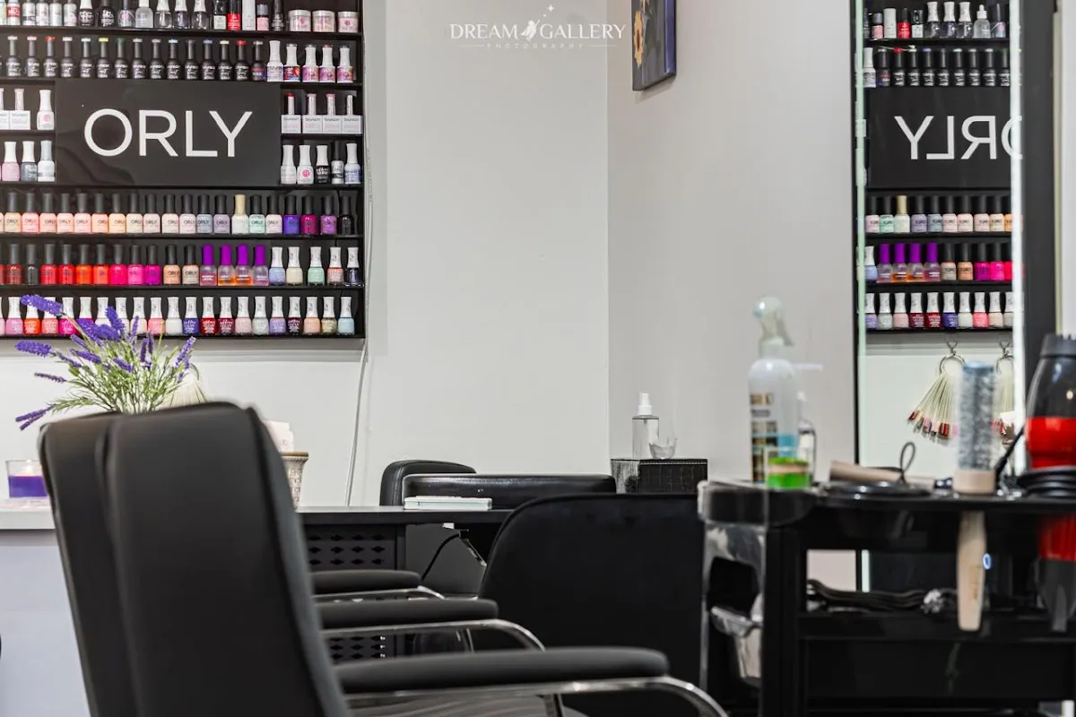 Interior of the salon with styling chairs and a wall of nail polish