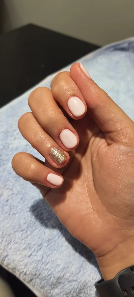 Soft nude pink gel manicure with a gold glitter accent nail at Aura & Elegance Ladies Salon