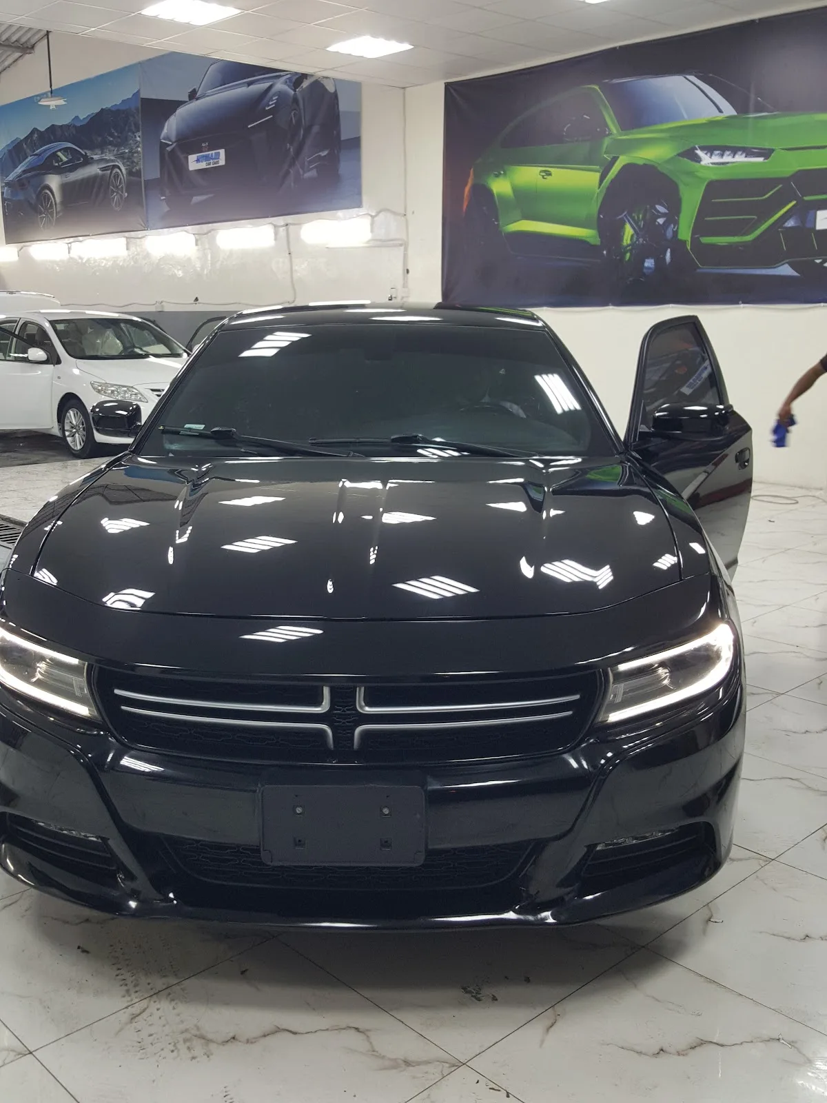 A glossy black Dodge Charger after detailing