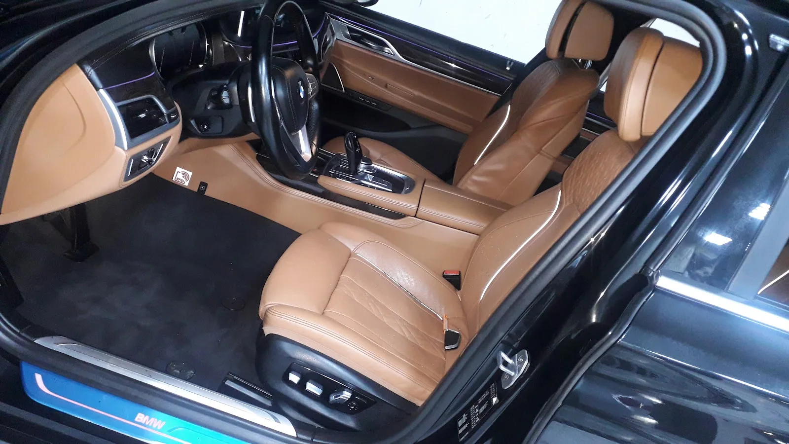 A clean tan-leather car interior detailed by HUMAID CAR CARE