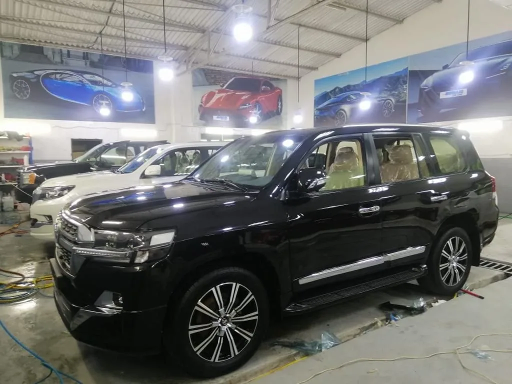 A black Toyota Land Cruiser being detailed