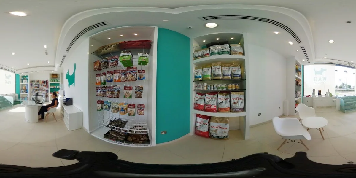 Shelves of dog and cat food at WAG Pet Care, including Royal Canin, beside the teal accent wall