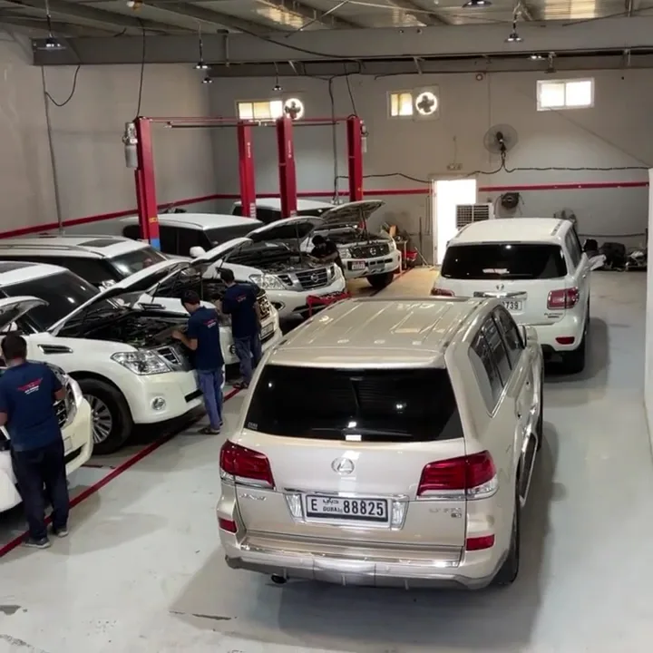 Technicians servicing several vehicles in the workshop