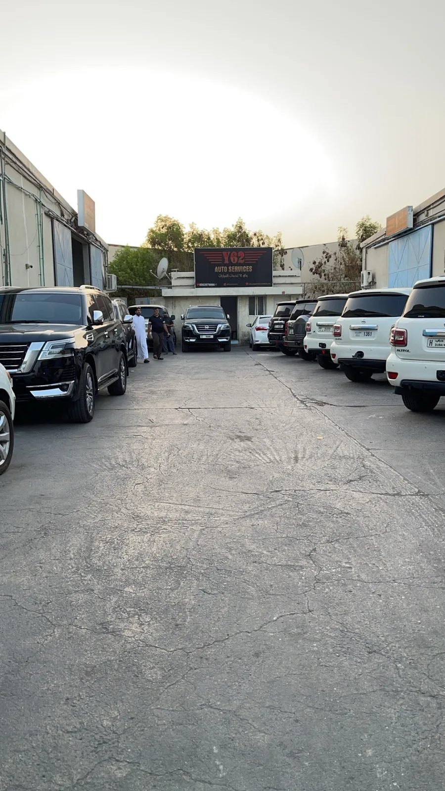 Exterior lot lined with parked Nissan Patrols