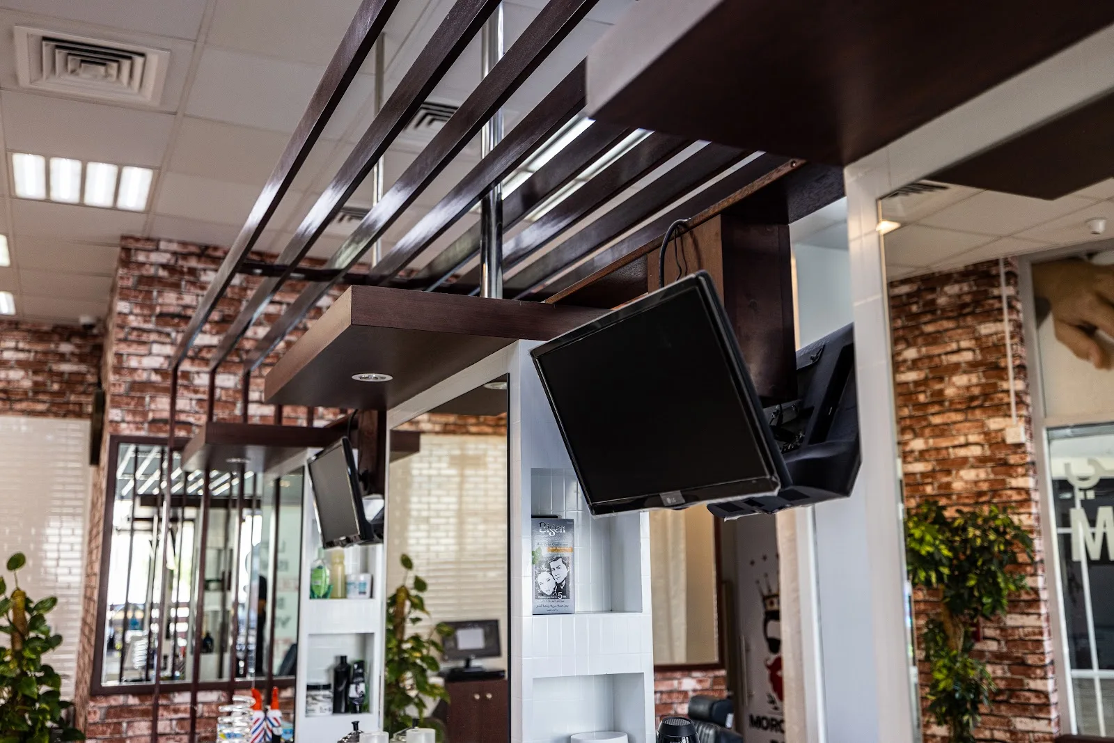 Dark wood-slat ceiling detail over the brick-walled grooming floor
