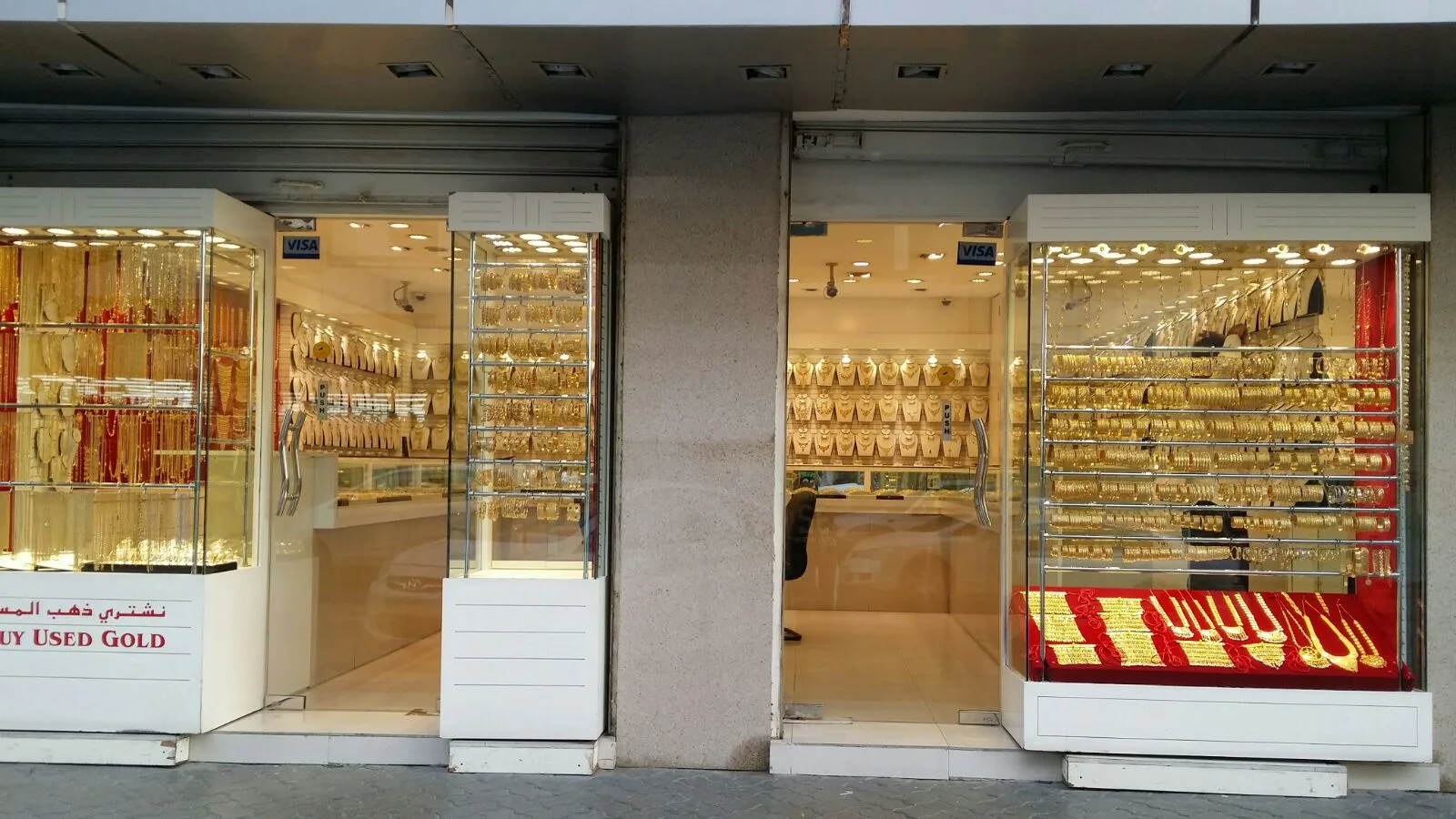 Two glass shopfront windows of Bu Yousif Jewellery filled with gold