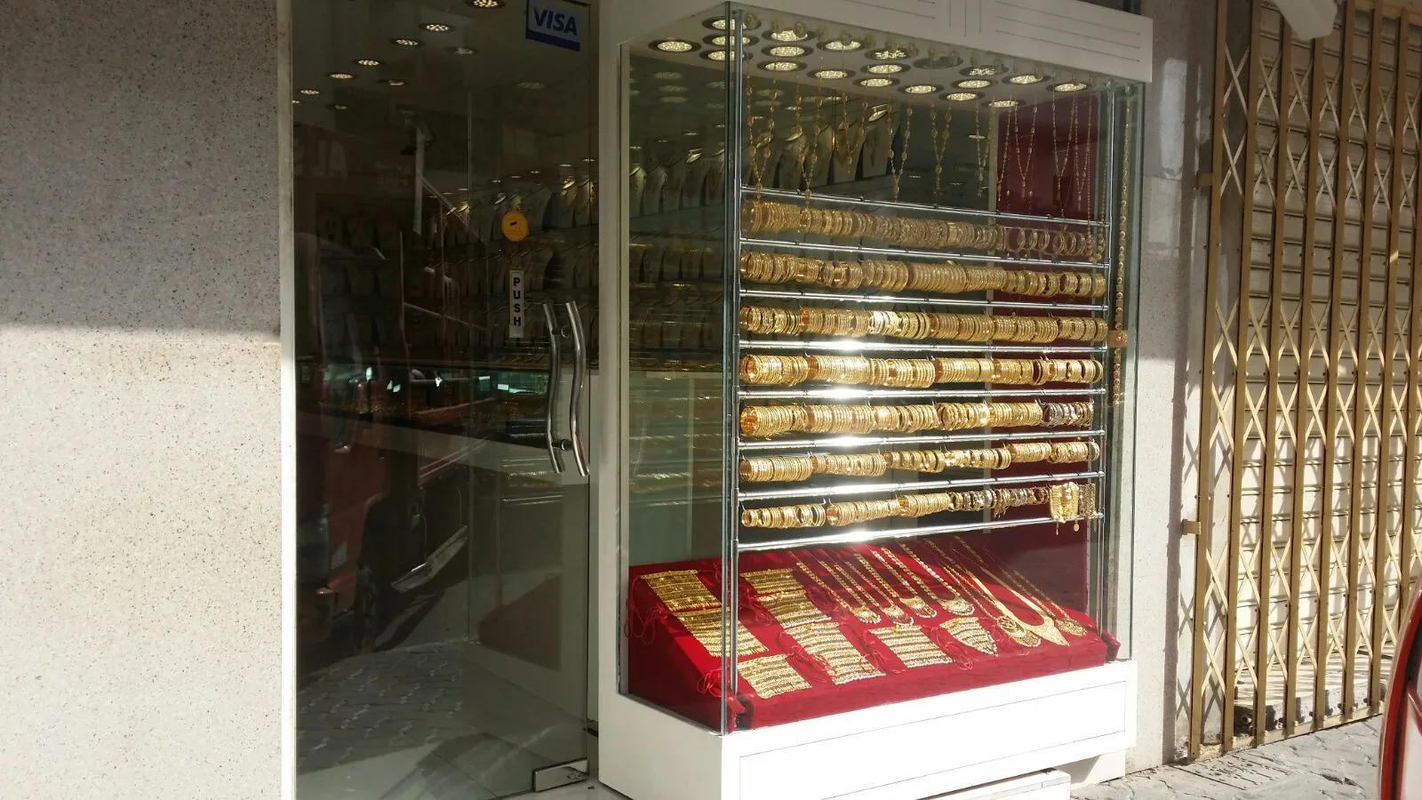 Rows of gold bangles in a glass window display case at Bu Yousif Jewellery
